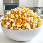 - 8 cups popped popcorn - 1 cup granulated sugar - 1/4 cup unsalted butter - 1/4 cup light corn syrup - 1/2 teaspoon salt - 1/2 teaspoon baking soda - 1 teaspoon vanilla extract - 2 cups mini marshmallows - Optional: 1/2 cup chopped nuts (e.g., pecans or peanuts) Gathering the right ingredients is key to making this tasty treat. Start with eight cups of popped popcorn. You can pop your popcorn on the stove or in an air popper. Just make sure it’s fresh and fluffy! Next, you need one cup of granulated sugar. This will give your caramel that sweet flavor we love. You’ll also need a quarter cup of unsalted butter. This adds richness to our caramel. You’ll need a quarter cup of light corn syrup. This helps keep the caramel smooth. Also, grab half a teaspoon of salt. It enhances the sweetness of the sugar. For some magic, you’ll need half a teaspoon of baking soda. This will make your caramel light and airy. You’ll also need one teaspoon of vanilla extract for that warm flavor. Finally, you’ll need two cups of mini marshmallows. They melt and blend with the caramel. If you like nuts, you can add half a cup of chopped nuts too. Pecans or peanuts work great! These ingredients will come together to make a treat everyone will love. Prepare them all before you start cooking for the best results! - Preheat your oven to 250°F (120°C) and line a large baking sheet with parchment paper. - In a medium saucepan over medium heat, combine 1 cup of granulated sugar, 1/4 cup of unsalted butter, 1/4 cup of light corn syrup, and 1/2 teaspoon of salt. Stir until the mixture starts to boil. - Let it boil without stirring for 4-5 minutes. You want it to turn a light golden color. - Remove the saucepan from heat. Quickly stir in 1/2 teaspoon of baking soda and 1 teaspoon of vanilla extract. Be careful; it will bubble up! - Place 8 cups of popped popcorn in a large mixing bowl. - Pour the caramel mixture over the popcorn. Stir to coat it evenly. - Gently fold in 2 cups of mini marshmallows and optional 1/2 cup of chopped nuts, like pecans or peanuts. - Spread the popcorn mixture evenly on the prepared baking sheet. - Bake for 20-25 minutes, stirring every 10 minutes. This helps it become crispy. - Remove from the oven and let it cool completely. Once cool, break into pieces and enjoy! To make great caramel, timing is key. Boil the mixture for 4-5 minutes. Keep the heat medium. Watch closely for the color change. You want a light golden hue. This means your caramel is just right. If it gets too dark, it may taste burnt. Presentation makes a big difference. Serve Marshmallow Caramel Corn in fun, colorful bags. You can also use decorative bowls. For extra flair, drizzle melted caramel on top. It adds a lovely shine and boosts flavor. Overcooking the popcorn is a common error. It can turn hard and chewy. Stir the popcorn enough while baking. This helps it cook evenly. If you don’t stir, some pieces may burn. Keep an eye on it for the best results. {{image_2}} You can easily change up the flavor of your Marshmallow Caramel Corn. One fun way is to add cocoa powder for a chocolate twist. This small addition gives your treat a rich cocoa flavor that kids and adults will love. You can start with two tablespoons and adjust to taste. Another great option is to include various nuts or candy. Adding nuts like pecans or peanuts gives a nice crunch. You can also mix in your favorite candy pieces. Think chocolate-covered treats or colorful candies for extra fun! If you need gluten-free options, worry not! Use gluten-free popcorn and check your corn syrup for gluten. Most brands are gluten-free, but it’s always good to check. For those who prefer vegan treats, you can substitute butter with coconut oil or vegan butter. This keeps the recipe plant-based while still being delicious. Want to add even more flavor? Consider mixing in dried fruits. Raisins, cranberries, or even chopped apricots can bring a sweet and chewy texture to your snack. You might also want to try other types of chocolate. Dark chocolate chips or white chocolate can change the taste. These options create a fun chocolatey surprise for your taste buds. To keep your marshmallow caramel corn fresh, store it in an airtight container. This helps protect it from air, which can make it stale. You can use any container that seals tightly. Glass jars or plastic bins work well. Avoid fabric bags or paper bags, as they let air in. When stored properly, your marshmallow caramel corn lasts about a week. After that, it may lose its crunch. Signs of spoilage include a soft texture or an off smell. If you notice either, it’s best to toss it. To refresh old popcorn, preheat your oven to 250°F (120°C). Spread the popcorn on a baking sheet. Heat it for about 5 to 10 minutes. This can help bring back some crunch. Keep an eye on it to avoid burning. The best way to pop popcorn is using an air popper. It gives you light and fluffy popcorn. You can also use the stovetop method. Heat a pot with some oil, then add the kernels. Shake the pot while it pops. This keeps the popcorn from burning. Avoid using microwave popcorn, as it often has added flavors that can change our treat. Yes, you can use pre-packaged popcorn. Look for plain popcorn without added butter or salt. This way, you will still get that tasty caramel and marshmallow flavor. Just remember to check the ingredient list. Some brands may add flavors that won't match well with caramel. To make this recipe nut-free, simply omit the nuts. The dish will taste just as delicious without them. If you want extra crunch, consider using sunflower seeds or pumpkin seeds. These seeds add texture and flavor without nuts. Yes, you can make Marshmallow Caramel Corn ahead of time. Store it in an airtight container to keep it fresh. It tastes best if eaten within one week. If stored correctly, it stays crunchy and delicious. To fix grainy caramel sauce, heat it gently while stirring. This helps the sugar dissolve again. If it stays grainy, add a bit of water and heat it slowly. Stir well until smooth. This should help restore the creamy texture you want. This recipe for Marshmallow Caramel Corn is both fun and easy. You learned essential steps, from gathering ingredients to perfecting the caramel. I shared tips for storage and common mistakes to avoid. With variations, you can customize flavors and adjust for dietary needs. This treat works well for parties, movie nights, or a sweet snack. Enjoy creating a delightful treat that everyone will love!
