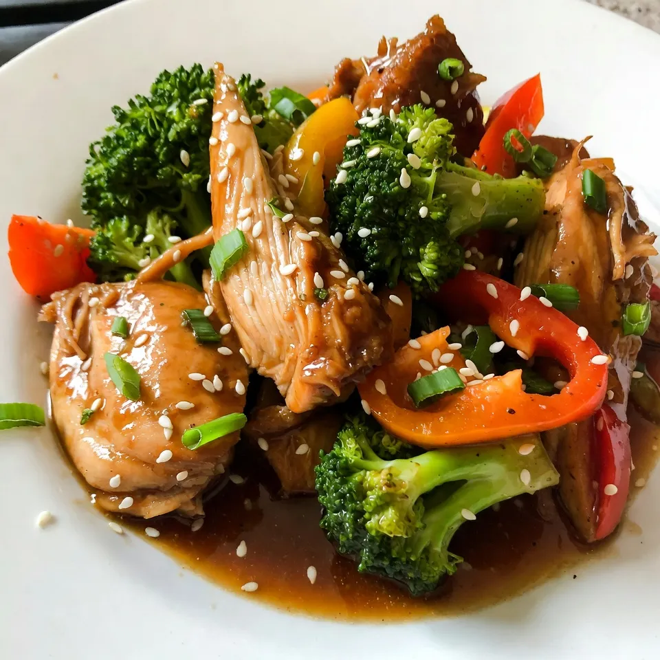 - 4 boneless, skinless chicken thighs - 1/2 cup honey - 1/4 cup soy sauce - 4 cloves garlic, minced - 1 tablespoon freshly grated ginger - 1 tablespoon sesame oil - 1/2 teaspoon crushed red pepper flakes - 1 cup broccoli florets - 1/2 cup sliced bell peppers - 1 tablespoon cornstarch mixed with 2 tablespoons water - Sesame seeds for garnish - Chopped green onions for garnish Use a liquid measuring cup for honey and soy sauce. A dry measuring cup works best for the cornstarch. Fresh herbs can enhance flavors, so use them if you have them. For more heat, add more crushed red pepper flakes or a dash of chili sauce. {{ingredient_image_1}} To start, gather your ingredients for the sauce. In a bowl, whisk together the honey, soy sauce, minced garlic, grated ginger, and sesame oil. If you like a little heat, add the crushed red pepper flakes. Mix well until everything combines. This step is key for a flavorful sauce that coats the chicken perfectly. Now, take your chicken thighs and lay them at the bottom of the slow cooker. Make sure the pieces fit snugly but don’t crowd them. Pour the honey garlic sauce over the chicken. Ensure every piece of chicken gets a nice coating. Cover the slow cooker and set it to cook on low for 6-7 hours or on high for 3-4 hours. The chicken will become tender and soak up all the flavors. About 30 minutes before the chicken is done, add the broccoli florets and sliced bell peppers to the slow cooker. Gently stir them into the sauce. This adds color and nutrition to your meal. Once it’s time to serve, remove the chicken and set it aside. Mix cornstarch with water, then stir it into the sauce. Cook on high for an extra 15 minutes to thicken. Shred the chicken with two forks, then return it to the slow cooker. Stir everything together for a delicious finish! Slow cooking works best with less liquid. The chicken releases juices, so you need less sauce. Always layer your ingredients. Start with the chicken at the bottom. This way, it cooks evenly. Use fresh ingredients for the best taste. For tender chicken, cook it low and slow. This method breaks down the meat fibers. I suggest cooking the chicken for 6-7 hours on low. If you are short on time, 3-4 hours on high works too. Always check the internal temperature. It should reach 165°F for safety. Presentation makes a big impact. Serve the honey garlic chicken over fluffy rice or quinoa. This adds texture and flavor. Sprinkle sesame seeds on top for crunch. Add chopped green onions for a fresh touch. These colors make the dish pop, making it even more appetizing. Pro Tips Marinate for Extra Flavor: Let the chicken marinate in the honey garlic sauce for at least 30 minutes before placing it in the slow cooker. This will enhance the flavor of the chicken. Use Fresh Ingredients: Opt for fresh garlic and ginger rather than powdered versions for a more vibrant and aromatic dish. Customize the Veggies: Feel free to add or substitute other vegetables like carrots, snap peas, or mushrooms based on your preference or what you have on hand. Adjust the Sweetness: If you prefer a less sweet dish, reduce the amount of honey or increase the soy sauce to balance the flavors. {{image_2}} You can swap chicken thighs for chicken breasts. Breasts work great but may be drier. Try using maple syrup instead of honey for a different flavor. You can also use tamari for a gluten-free option instead of soy sauce. For a veggie boost, add snap peas, carrots, or spinach. If you like heat, add more crushed red pepper flakes. A teaspoon can give it a nice kick. For a milder dish, skip the flakes completely. You can also add a splash of sriracha or chili sauce for a warm touch. Adjust based on your family's taste preferences. Serve the honey garlic chicken over steamed rice or quinoa. This helps soak up the tasty sauce. You can also pair it with noodles for a fun twist. Don’t forget to sprinkle sesame seeds and green onions on top for a pretty finish. Serve with a side salad or steamed veggies for a complete meal. To store leftovers safely, first let the chicken cool. Place it in an airtight container. Make sure to include any sauce and veggies. Store in the fridge for up to three days. If you want to keep it longer, consider freezing. When you're ready to eat the leftovers, reheat them gently. You can use a microwave or a skillet. If using a microwave, heat on medium power for a few minutes. Stir the chicken and sauce halfway through. In a skillet, warm over low heat until hot. Add a splash of water if the sauce is too thick. To freeze, place the cooled chicken in a freezer-safe bag. Squeeze out excess air and seal tightly. This dish freezes well for up to three months. When you're ready to enjoy it again, thaw it overnight in the fridge. Then, reheat as mentioned above for the best taste. Yes, you can use chicken breasts instead of thighs. Chicken breasts will cook faster. They can dry out if overcooked, so keep an eye on them. Use the same cooking times but check for doneness. Thighs are juicier and more forgiving, so they are ideal. To make this dish gluten-free, swap soy sauce for tamari. Tamari is a gluten-free soy sauce. You can also use coconut aminos for a sweet taste. Ensure all other ingredients, like cornstarch, are gluten-free too. Always check labels for hidden gluten. You can serve honey garlic chicken with steamed rice or quinoa. Both pair well with the sweet sauce. Roasted vegetables make a nice side too. Try serving it with a fresh salad for crunch. Noodles also work great for a filling meal. This blog post outlined how to make a delicious honey garlic chicken dish. You learned about key ingredients, step-by-step cooking instructions, and helpful tips. We explored variations and storage ideas to keep your meals fresh. Remember, slow cooking makes the chicken tender, and garnishing can elevate your dish. I hope these insights help you create a tasty meal that friends and family will love. Enjoy your cooking adventure!